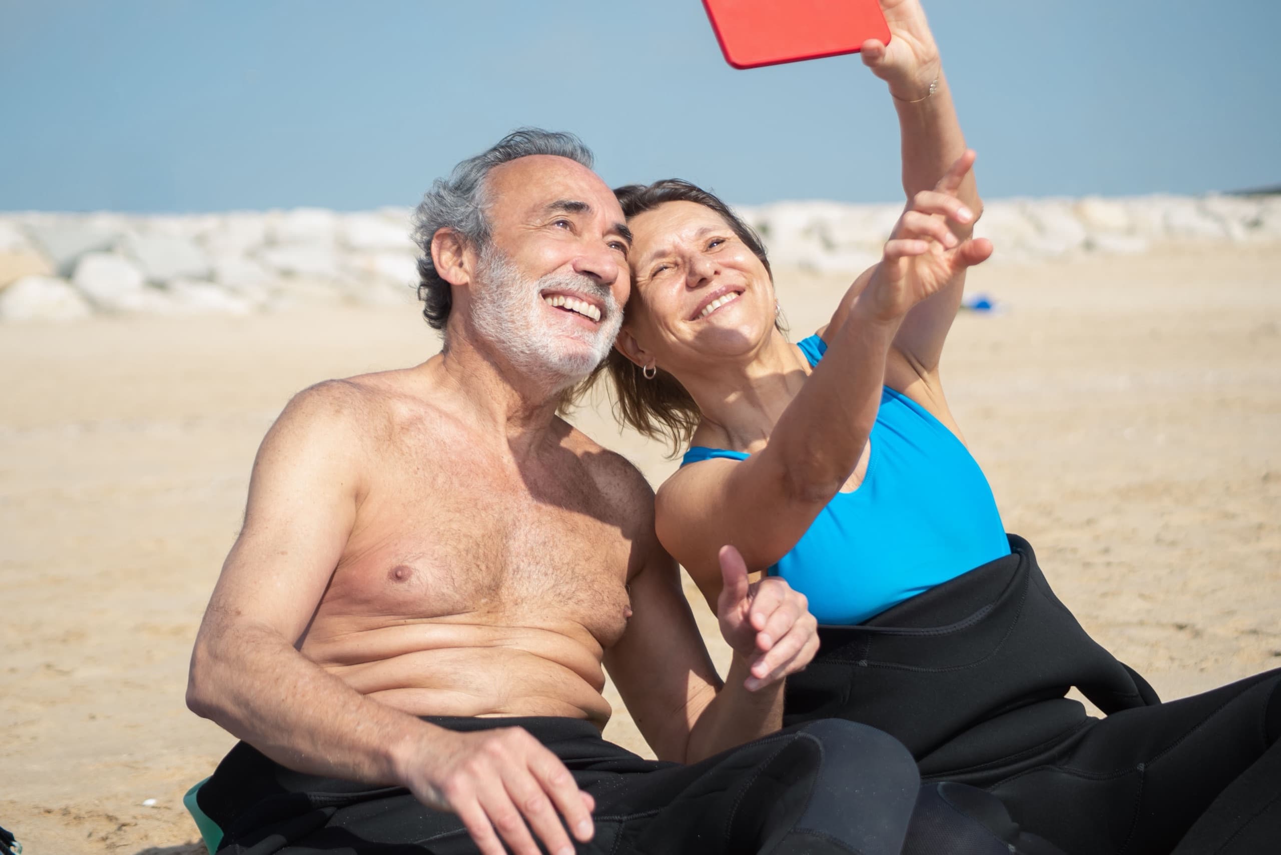 A couple laughing together on the beach